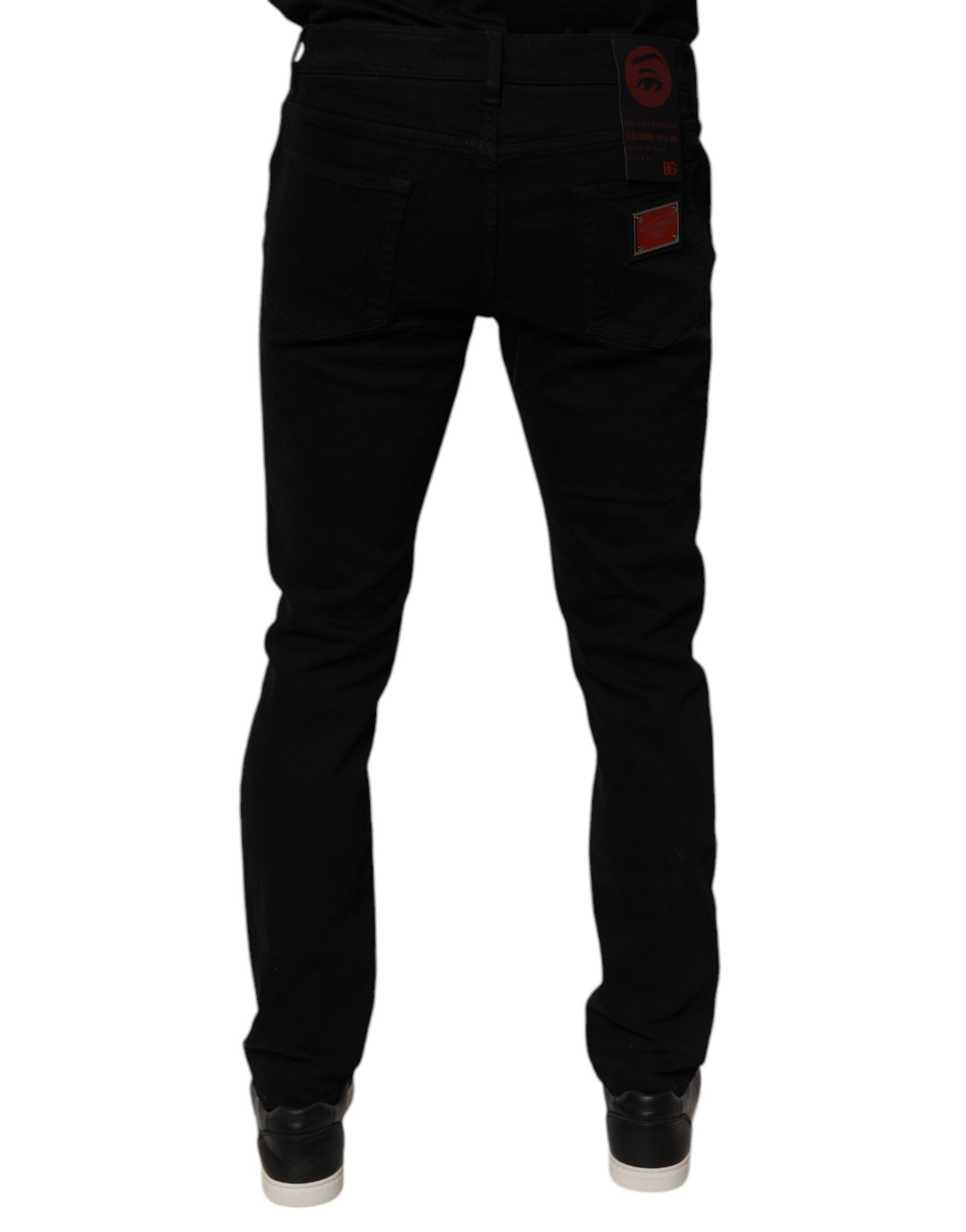Jeans homme skinny en denim noir déchiré de Dolce & Gabbana, coupe ajustée et détails usés visibles.