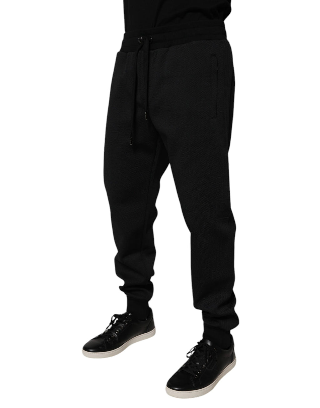 Pantalon jogging homme Dolce & Gabbana en polyester noir, coupe décontractée avec ceinture élastique et poches latérales.