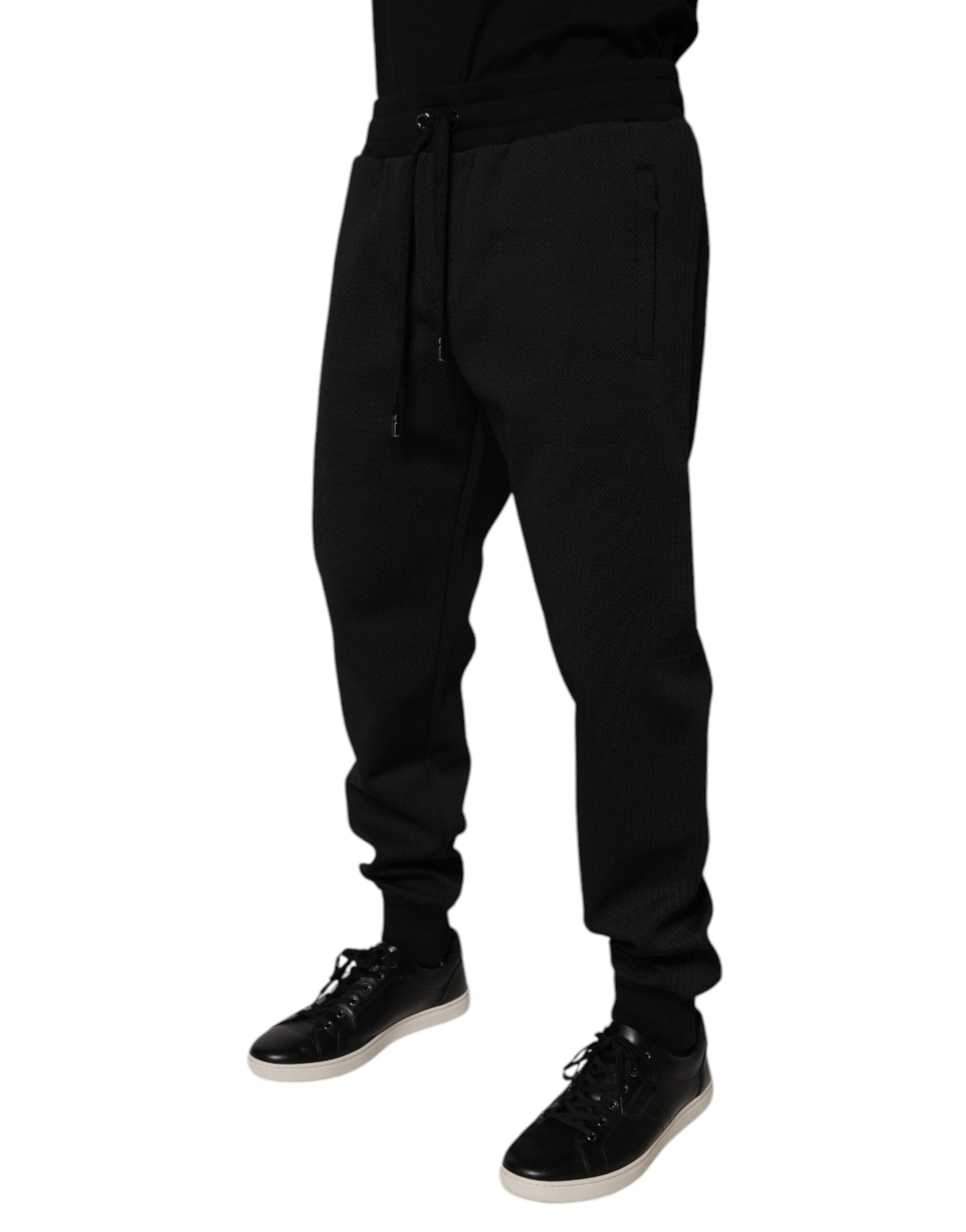 Pantalon jogging homme Dolce & Gabbana en polyester noir, coupe décontractée avec ceinture élastique et poches latérales.