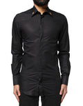 Chemise pour homme Dolce & Gabbana noire avec croix ornementale, détails élégants, style sophistiqué et luxe.