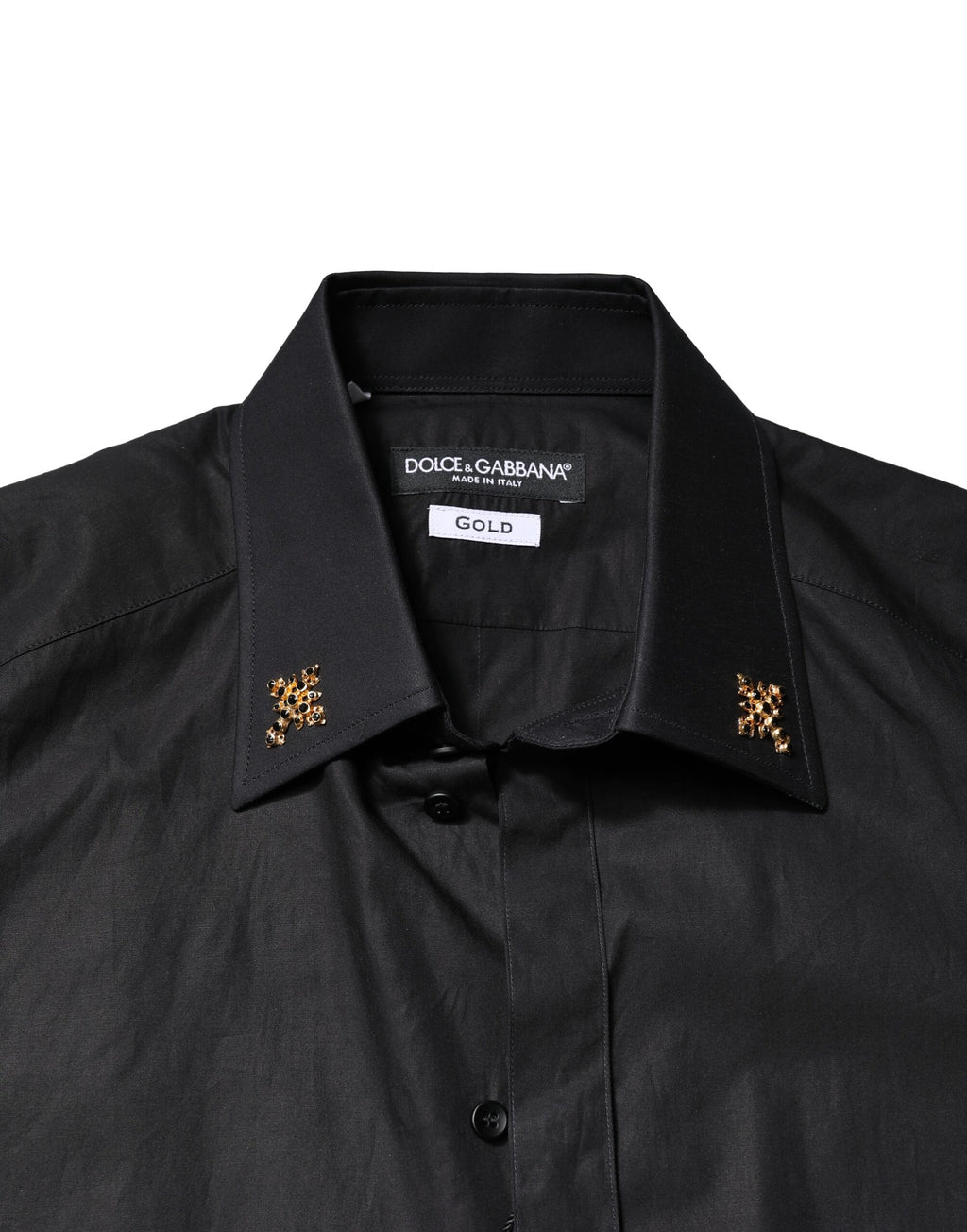 Chemise homme Dolce & Gabbana noire avec croix dorée ornée de bijoux, élégante et sophistiquée.