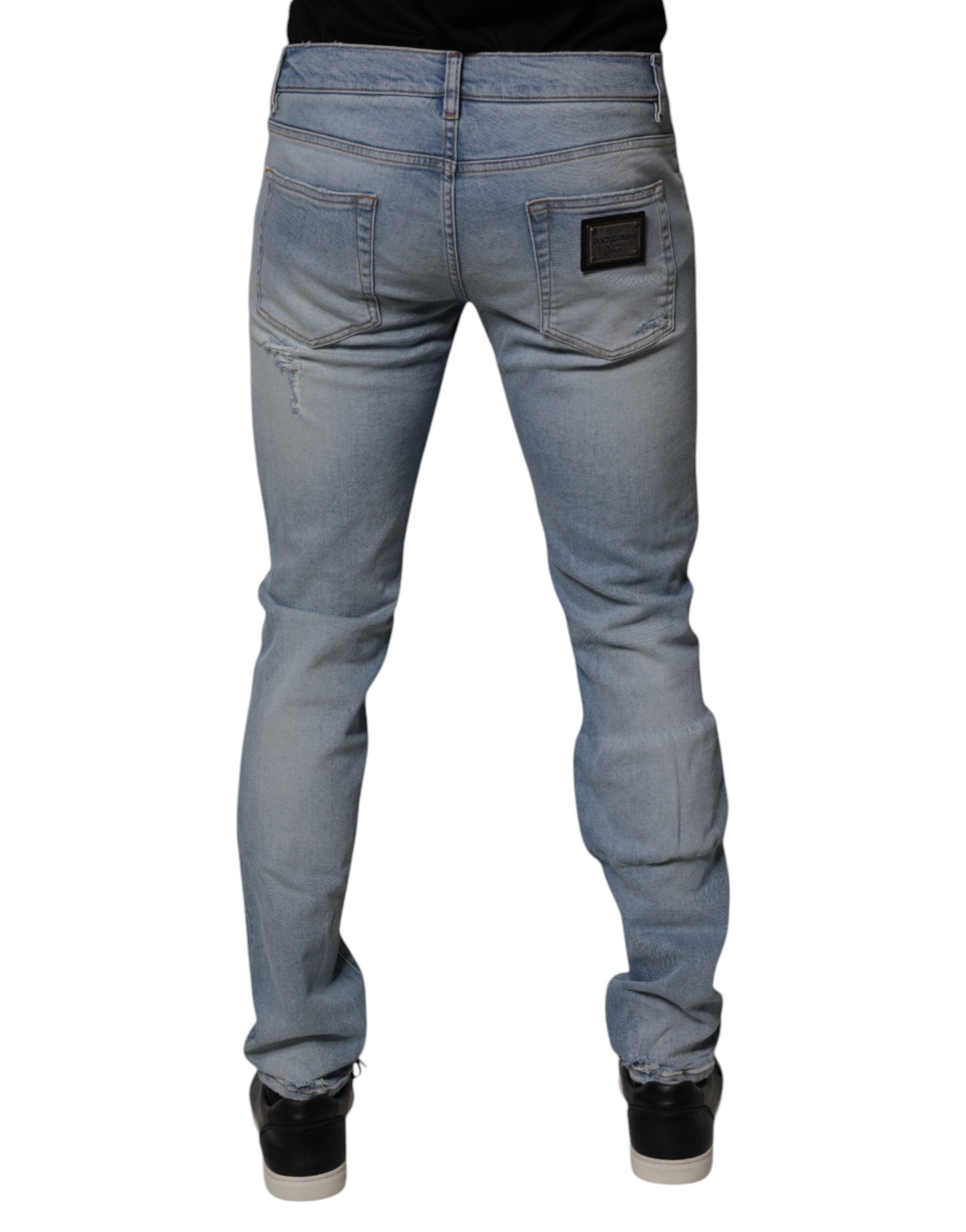 Jeans skinny en denim déchiré en coton bleu de Dolce & Gabbana pour homme, style tendance et moderne.