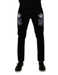 Jeans homme Dolce & Gabbana en coton noir avec motif floral, coupe skinny, en denim ajusté et élégant.