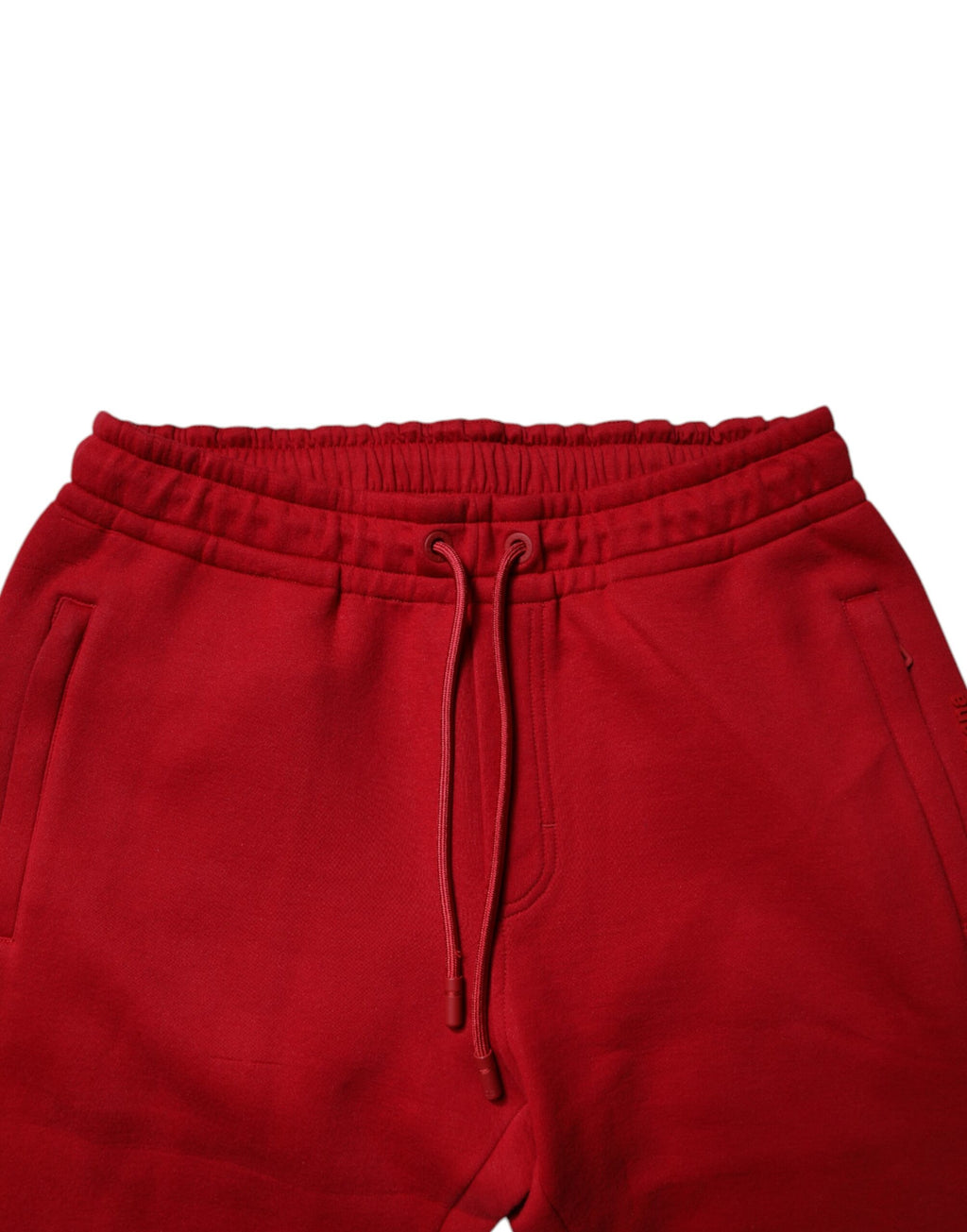 Pantalon de jogging rouge Dolce & Gabbana avec logo DG en coton pour homme, style décontracté et confortable.
