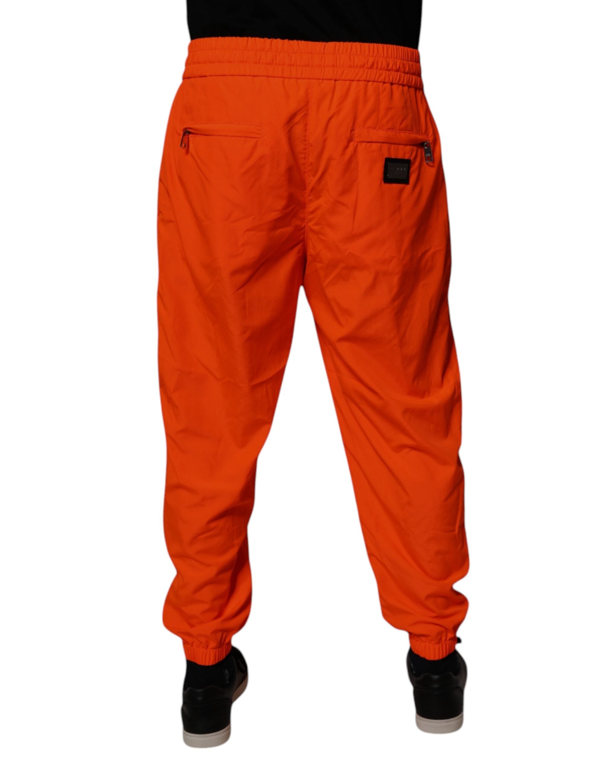 Pantalon jogging homme Dolce & Gabbana en polyester orange, style décontracté avec ceinture élastique.