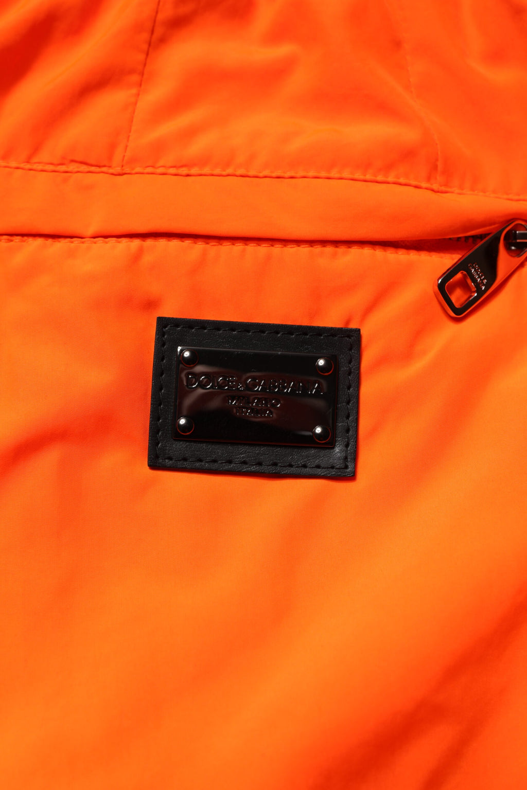 Pantalon jogging pour homme Dolce & Gabbana en polyester orange, style décontracté avec ceinture élastique et poches latérales.