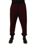 Pantalon jogger homme Dolce & Gabbana en coton bordeaux, style décontracté avec cordon de serrage et poches latérales.