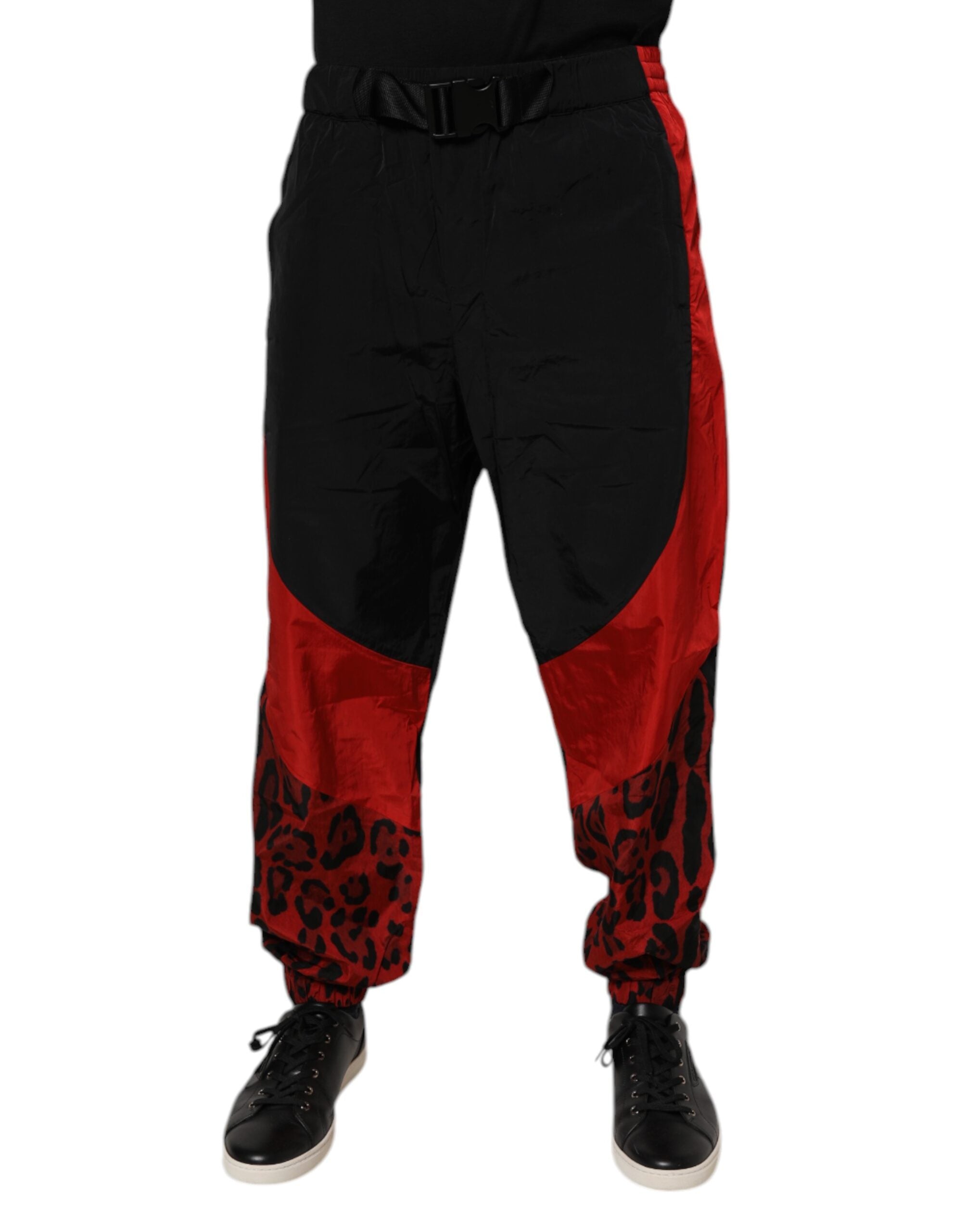 Pantalon jogger Dolce & Gabbana en velours noir avec motif léopard rouge et noir, style décontracté et tendance.