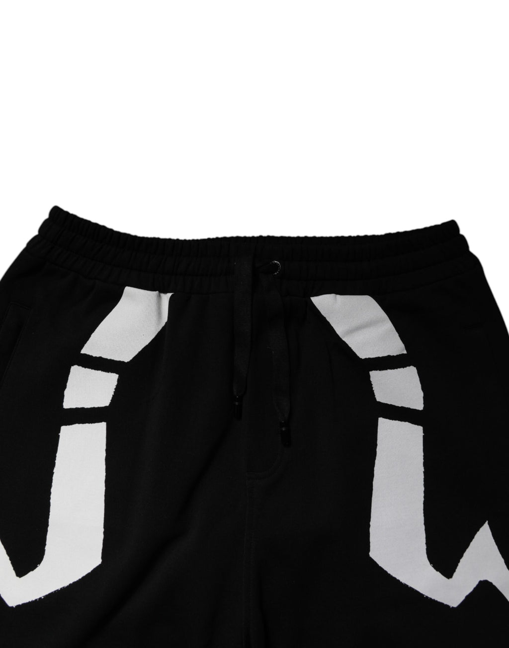 Pantalon jogger en coton noir Dolce & Gabbana avec logo, confortable et décontracté, visible avec poche latérale et taille élastique.