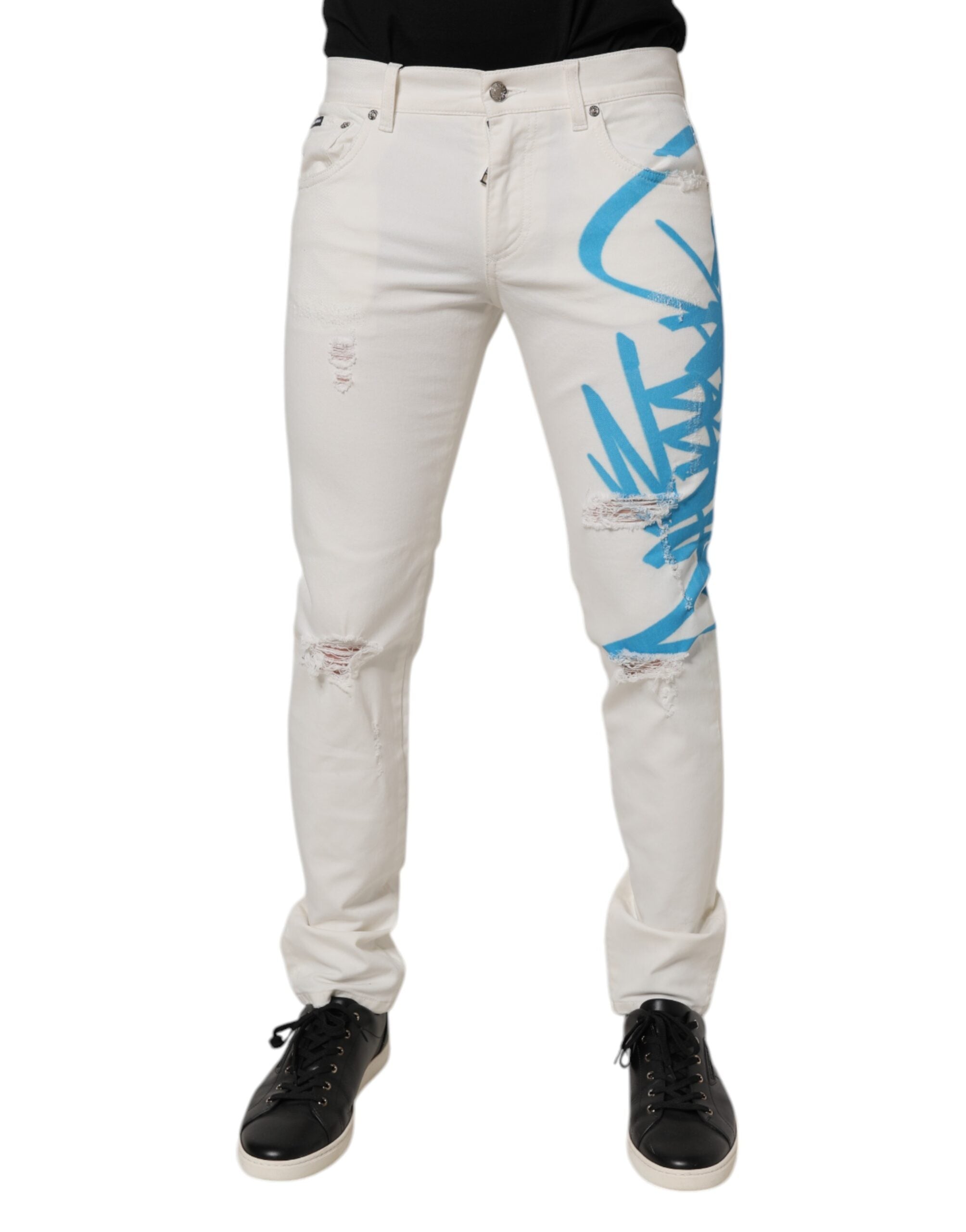 Jeans skinny en denim blanc Dolce & Gabbana avec déchirures et graffiti, mode urbaine sophistiquée.