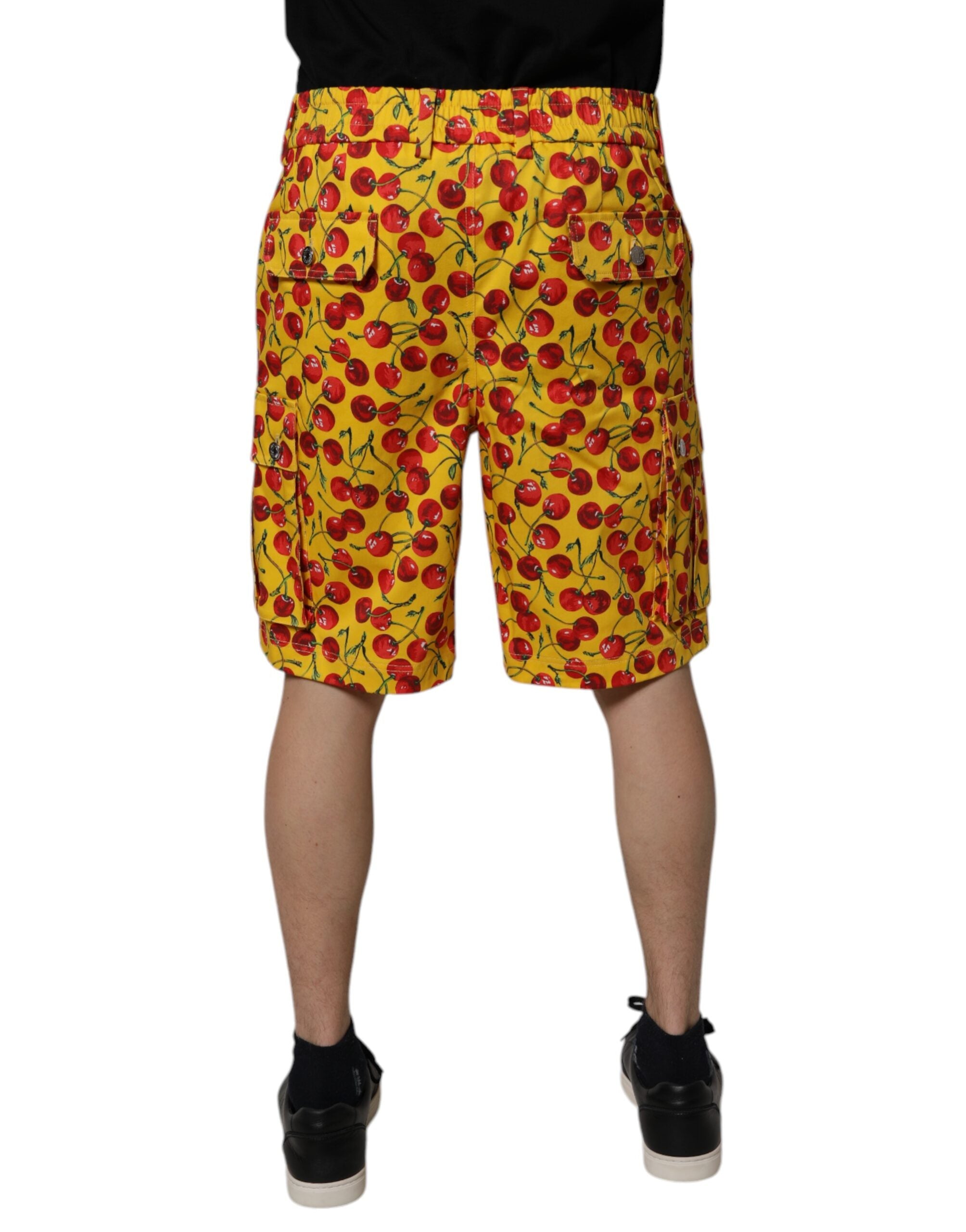 Shorts bermuda en coton jaune à imprimé cerises de Dolce & Gabbana pour homme, avec design coloré et style décontracté.
