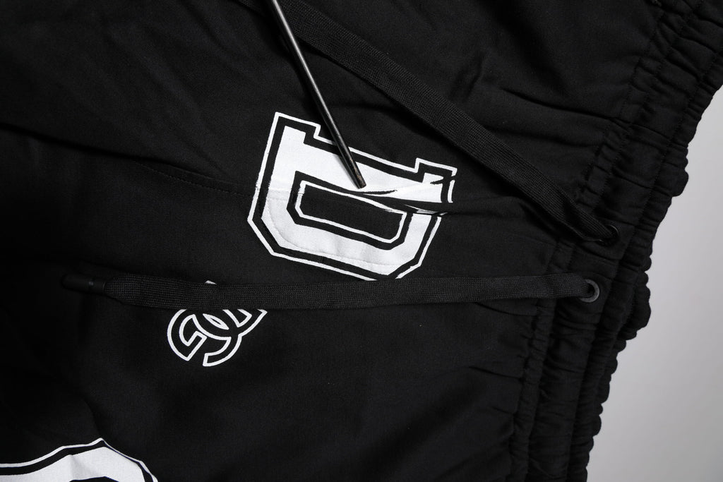 Shorts bermuda en coton noir avec logo Dolce & Gabbana, sweatshorts décontractés et confortables pour homme.