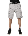 Shorts bermuda en jean gris clair déchiré pour homme de Dolce & Gabbana, denim léger et style décontracté.