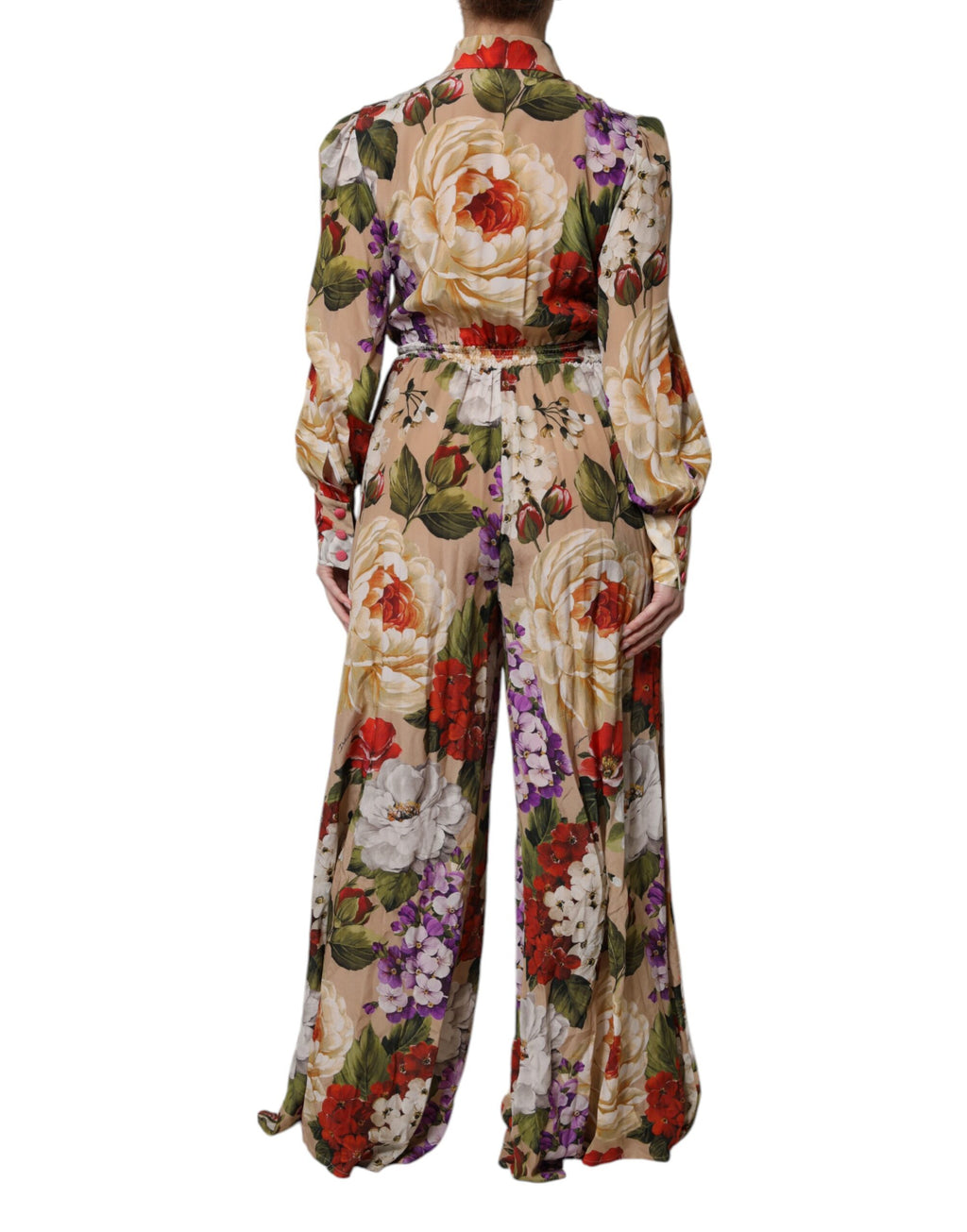 Combinaison pantalon Dolce & Gabbana à fleurs multicolores, coupe large, élégante et fluide, portée avec style.
