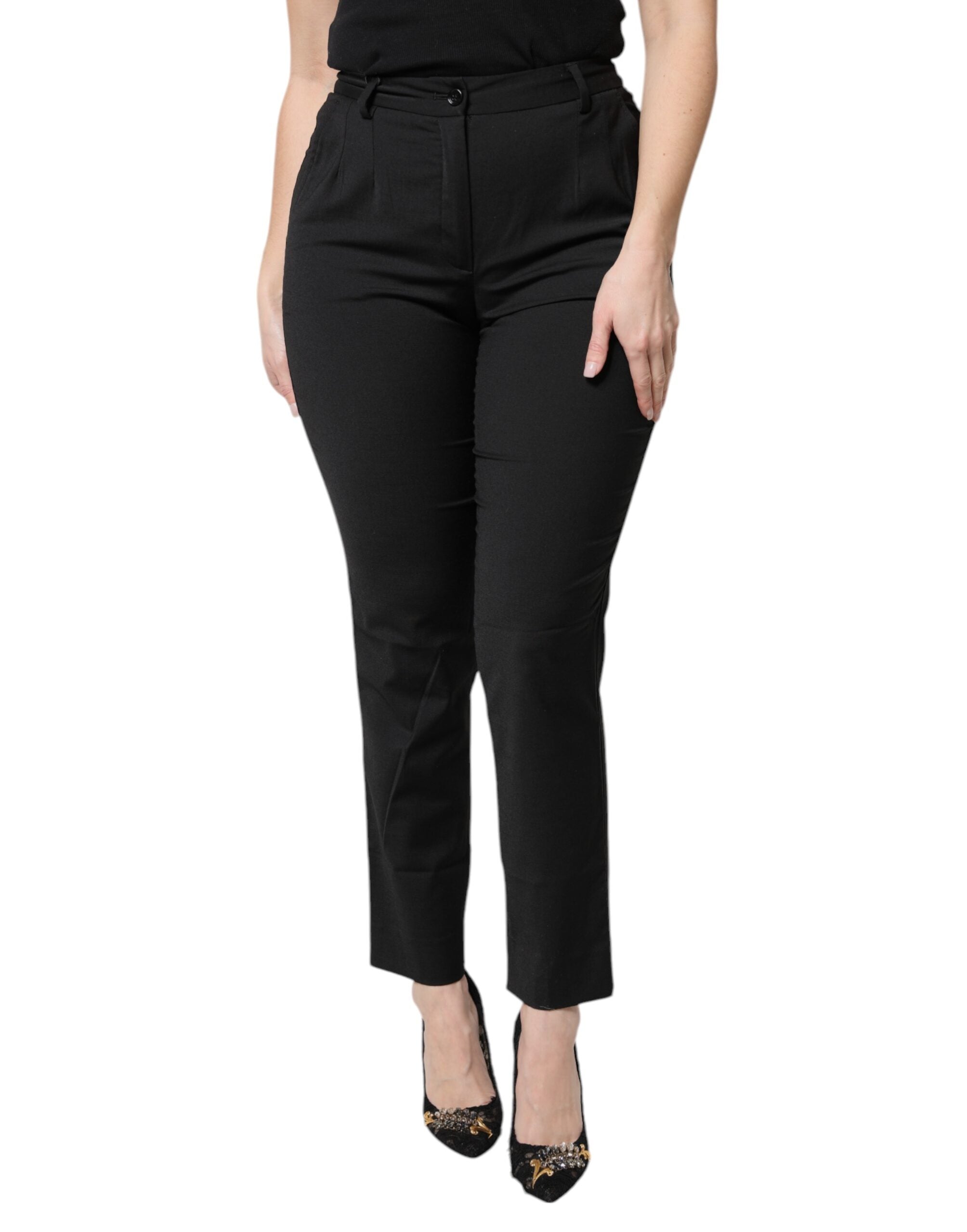 Pantalons noirs en polyester à taille haute et coupe slim de Dolce & Gabbana, vue de face.