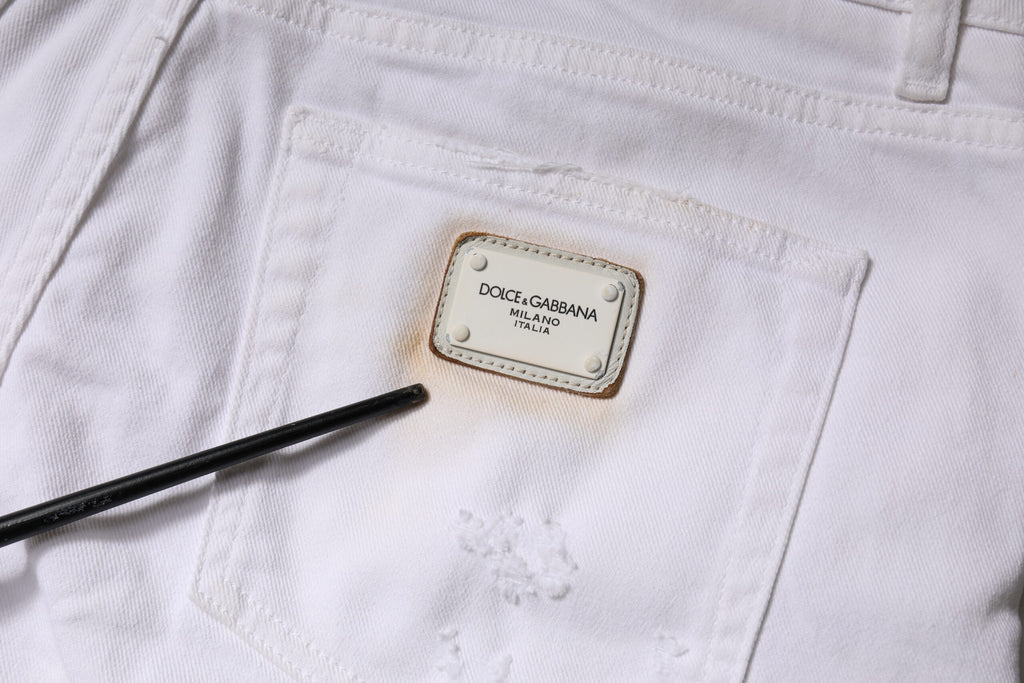 Jeans skinny en coton blanc à taille haute de Dolce & Gabbana, détails en denim, coupe ajustée et élégante.