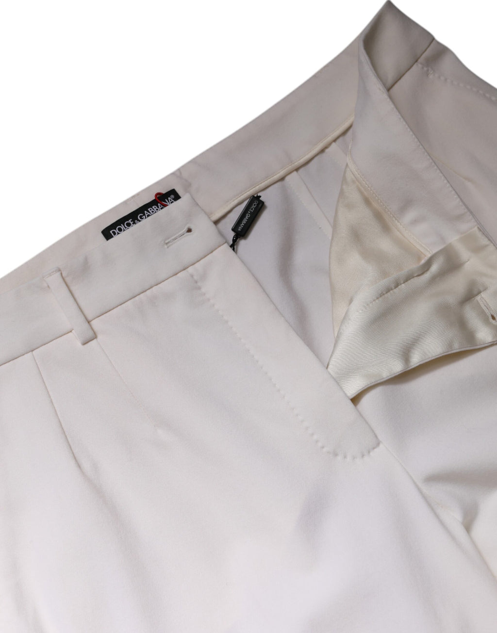 Pantalon en laine blanche Dolce & Gabbana, taille moyenne, à jambes larges et coupe élégante, visible en gros plan.