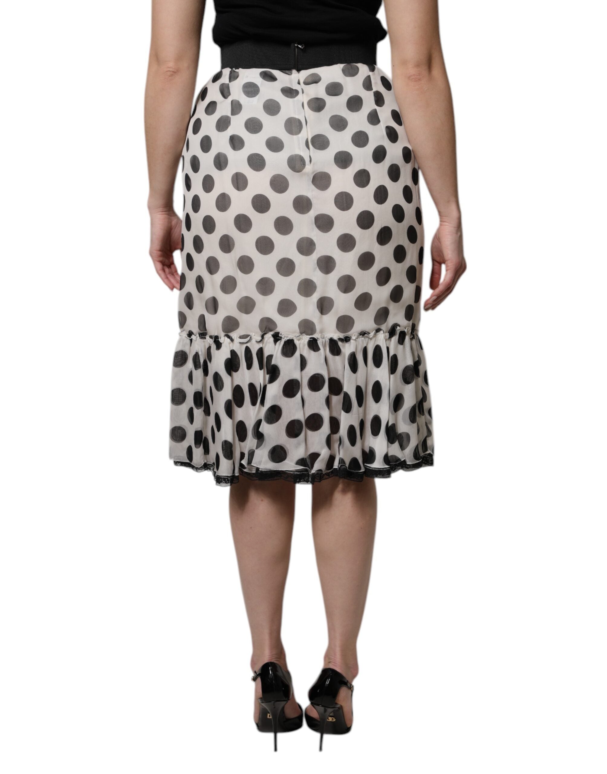 Jupe longue au genou Dolce & Gabbana blanche et noire à pois, élégante et fluide, en tissu léger.