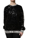 Pull en maille Dolce & Gabbana noir avec sequins DG Queen, détail brillant et coupe ajustée visible sur l'image.