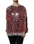 Pull noir Dolce & Gabbana DG Queen avec sequins roses, style élégant et brillant, en gros plan sur le pull.