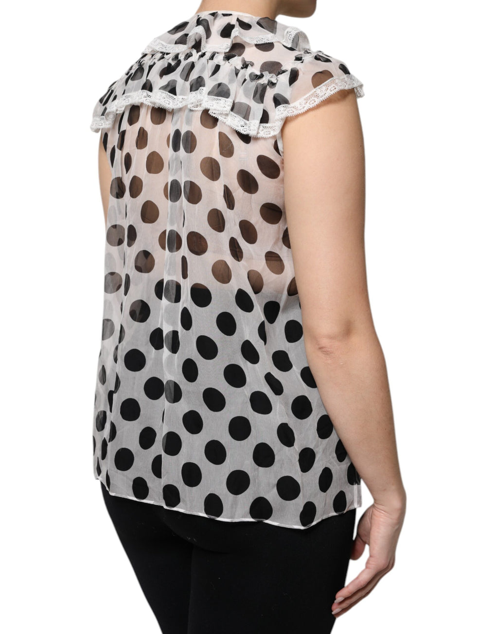 Haut sans manches en coton blanc et noir à pois de Dolce & Gabbana, style élégant et léger, visible en détail dans l'image.