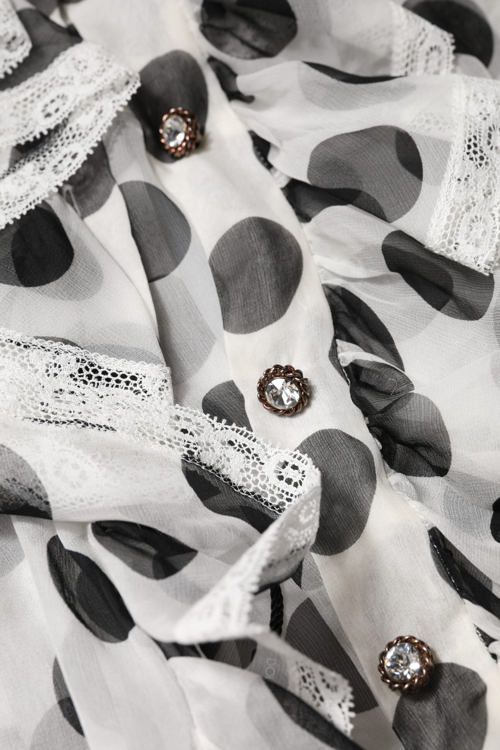 Haut sans manches en coton blanc et noir à pois de Dolce & Gabbana, style élégant et chic.