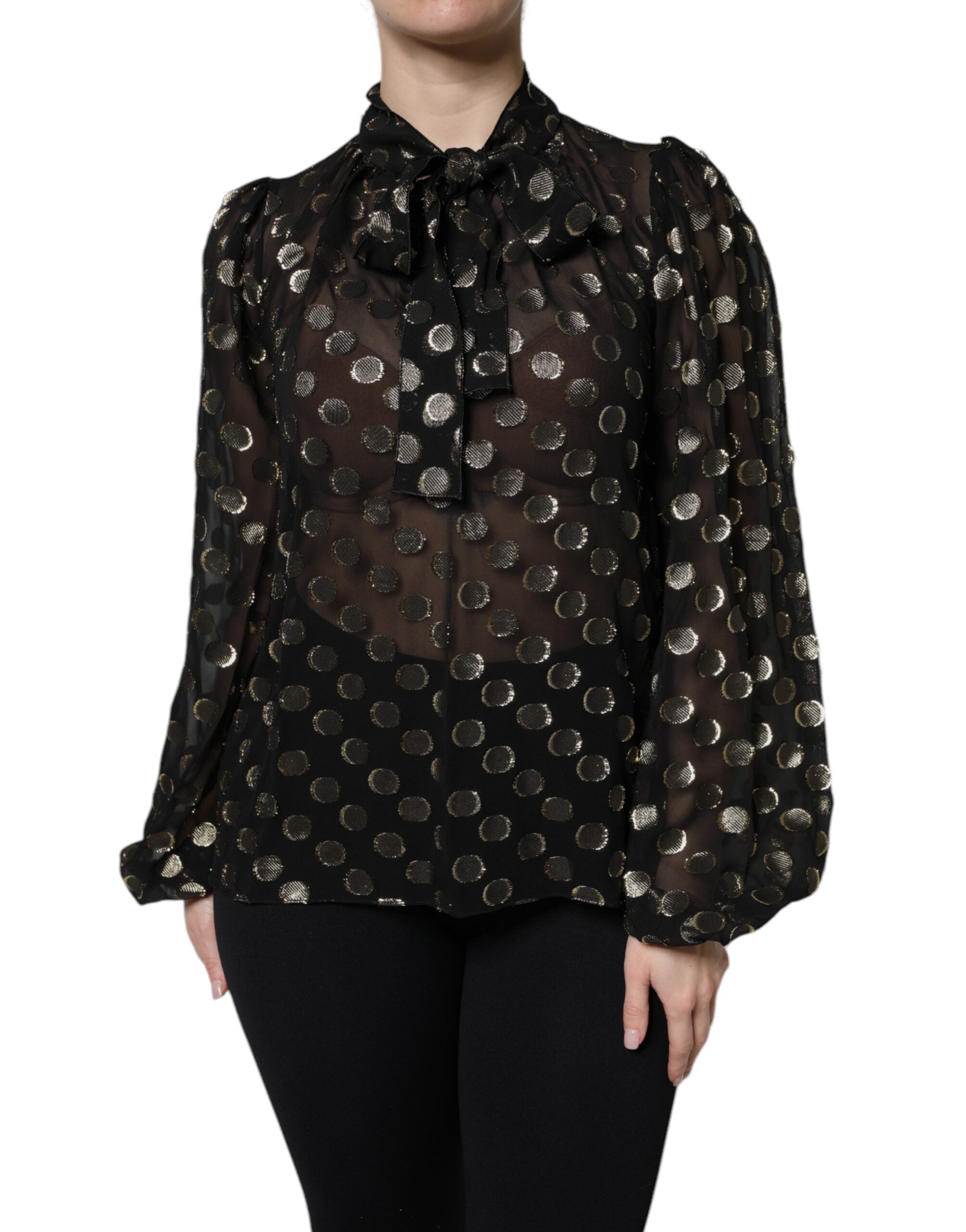 Blouse noire en dentelle transparente Dolce & Gabbana avec col noué à pois noirs et blancs, style élégant et féminin.