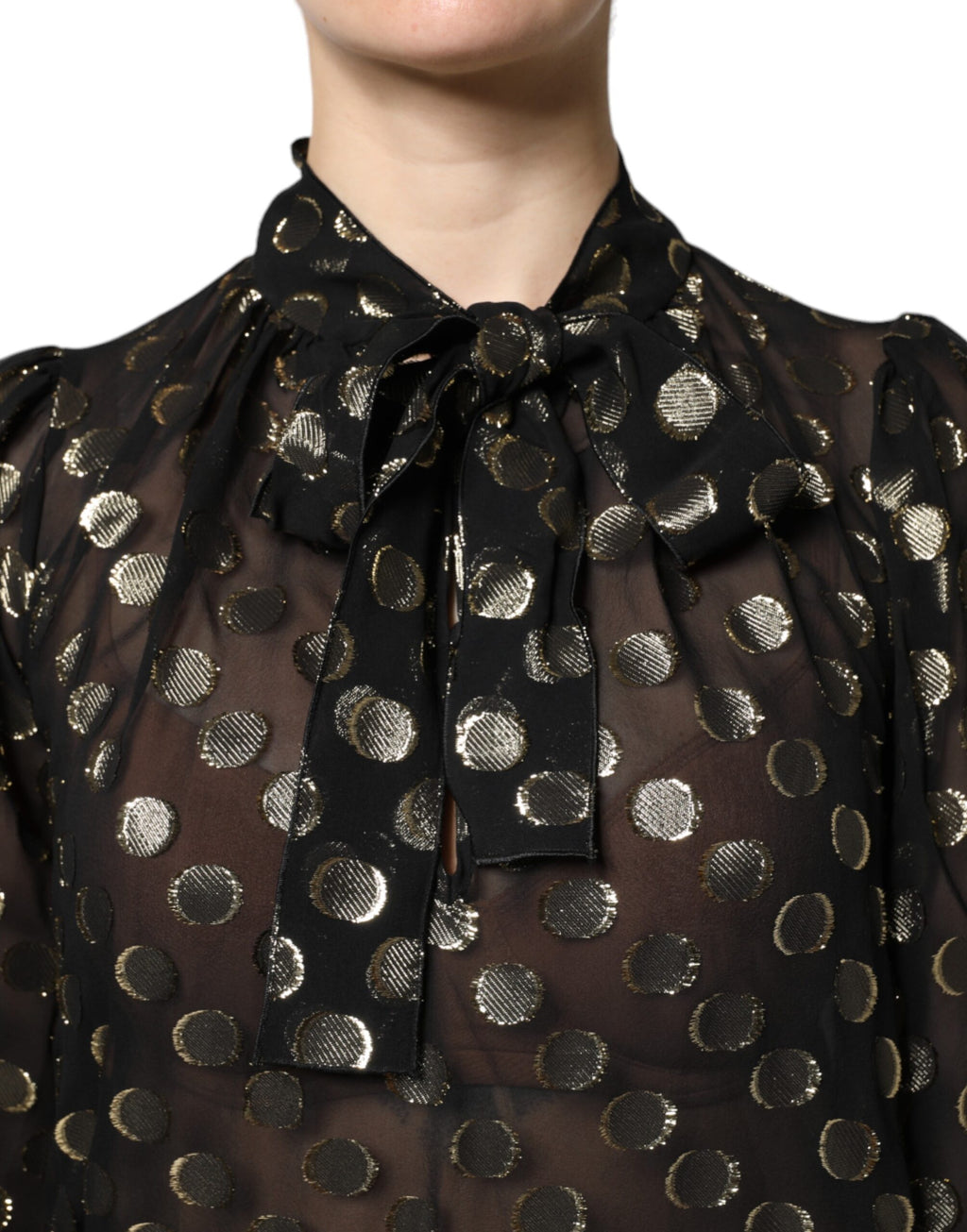Blouse noire en dentelle transparente Dolce & Gabbana avec nœud au col et motifs à pois.