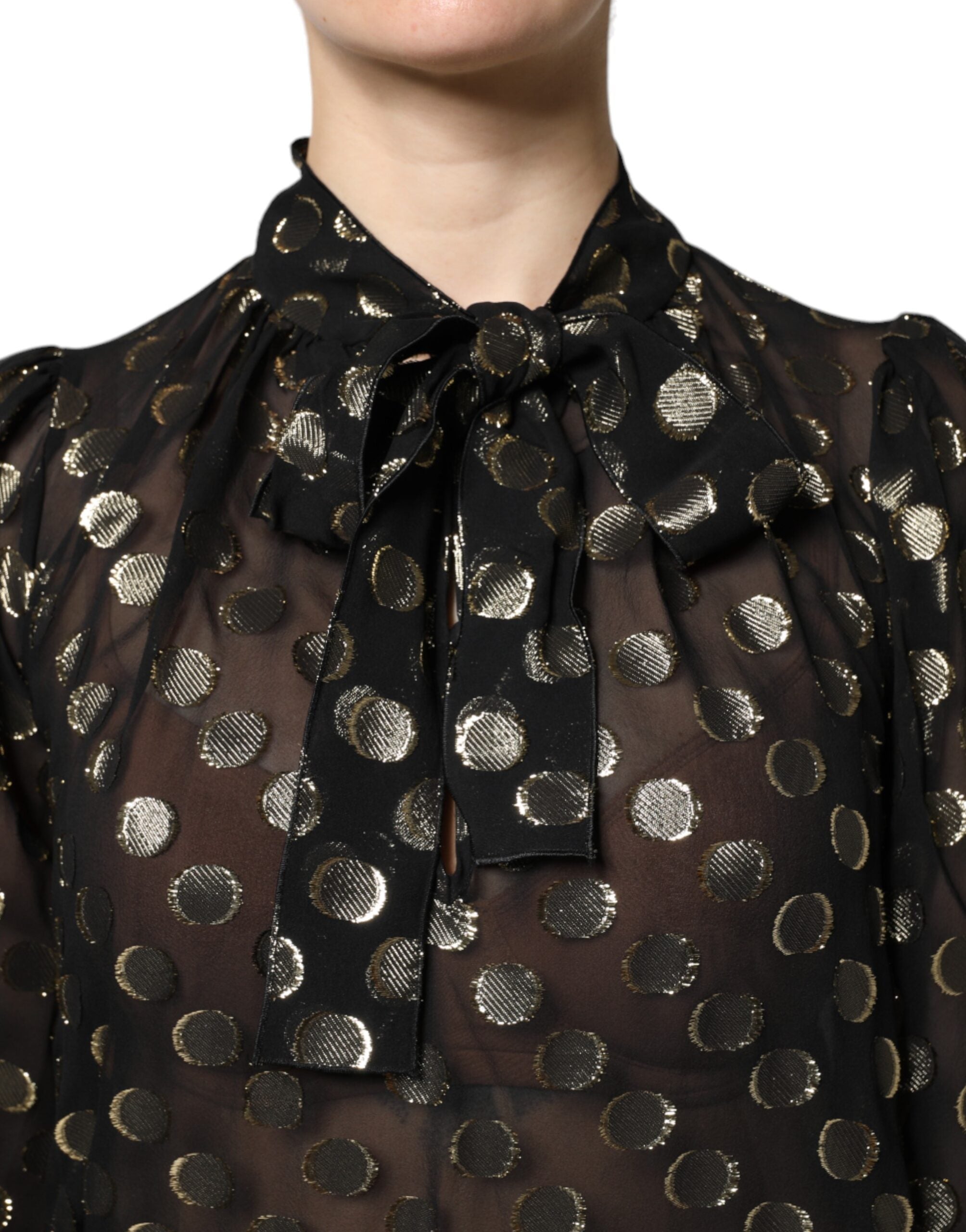 Blouse noire en dentelle transparente Dolce & Gabbana avec nœud au col et motifs à pois.