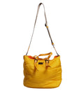 Sac à main et épaule Dolce & Gabbana en nylon jaune et orange avec plaque logo, style duffle, visible avec poignée et détails.