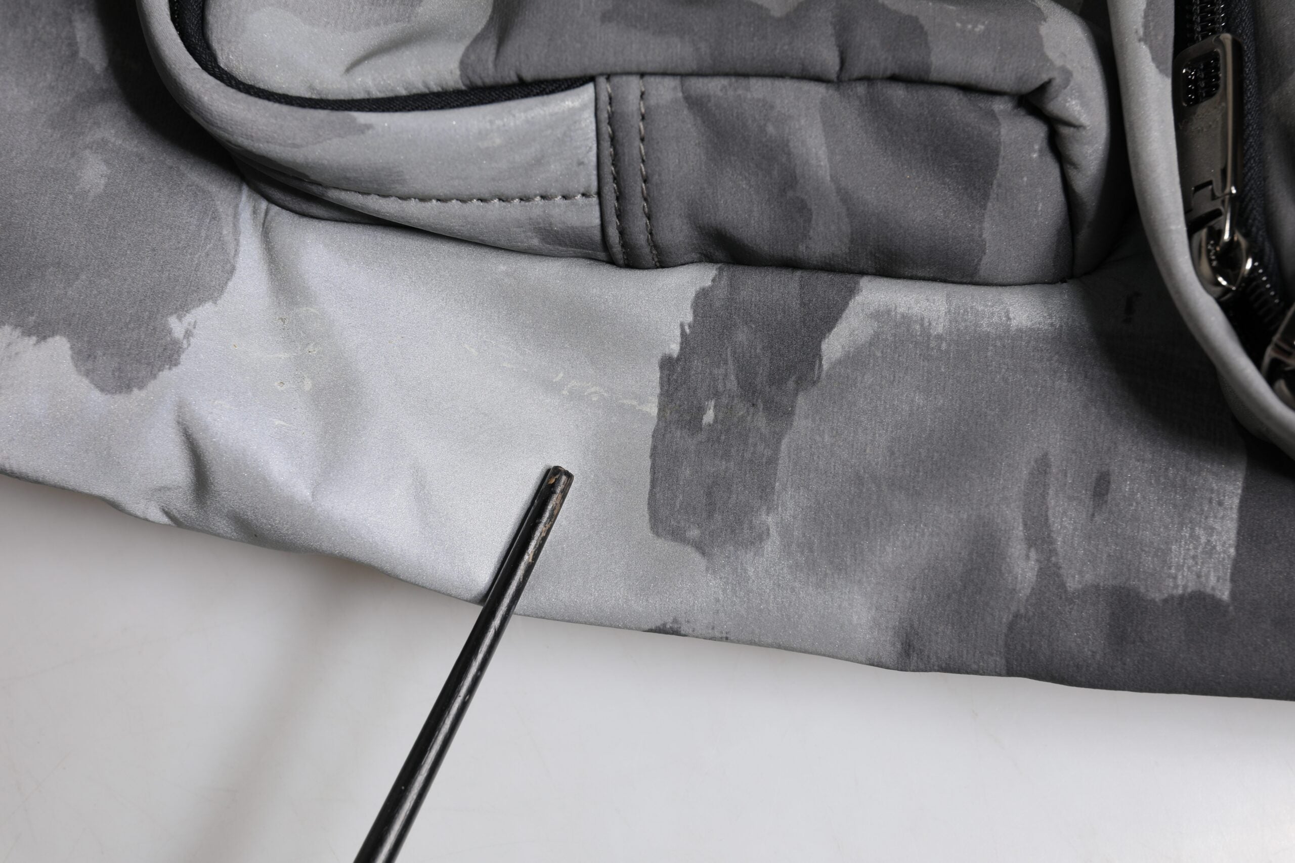 Sac Dolce & Gabbana noir avec bandoulière camouflage, plaque logo visible, design élégant et moderne.
