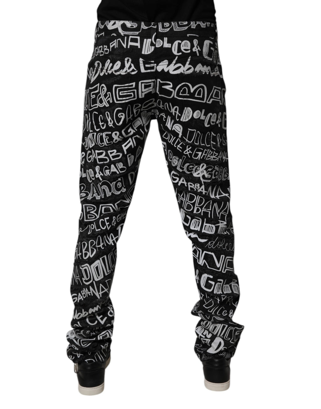 Jeans droits en denim noir Dolce & Gabbana avec logo imprimé, tissu en coton, visible sur l'image.