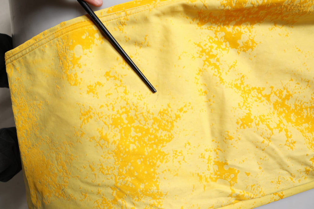 Jeans en denim droit en coton tie-dye jaune de Dolce & Gabbana, visibles avec leur motif coloré et coupe classique.