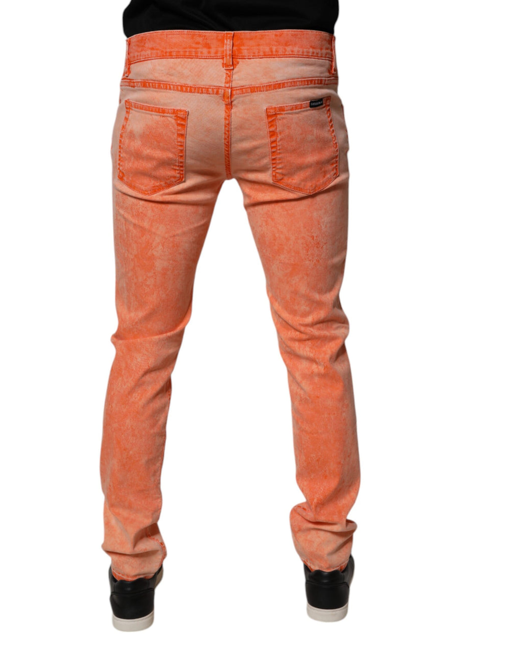 Jeans skinny en coton tie-dye orange de Dolce & Gabbana pour homme, denim avec ajustement près du corps.