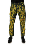 Jeans skinny homme Dolce & Gabbana en denim noir et jaune tie-dye avec déchirures et style tattered, mode moderne et tendance.
