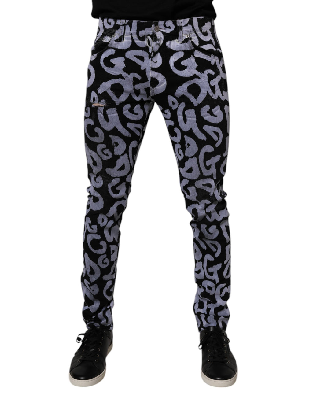 Jeans skinny en denim noir Dolce & Gabbana avec logo monogramme en coton, visible détails de la coupe et de la texture.