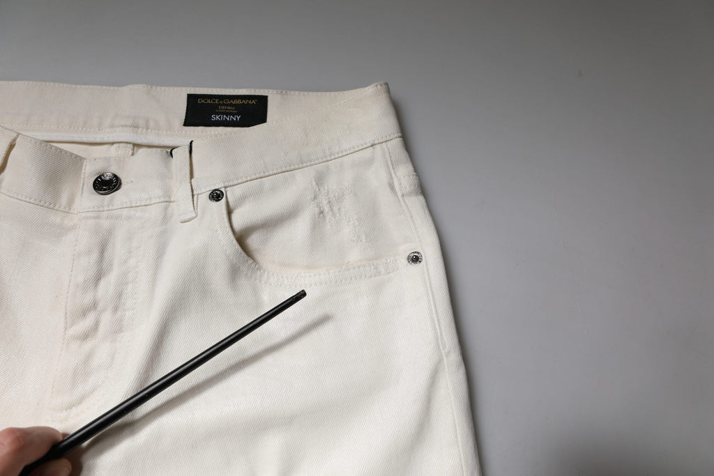Jeans skinny en denim stretch blanc en coton Dolce & Gabbana, coupe ajustée et tendance, vue de face.