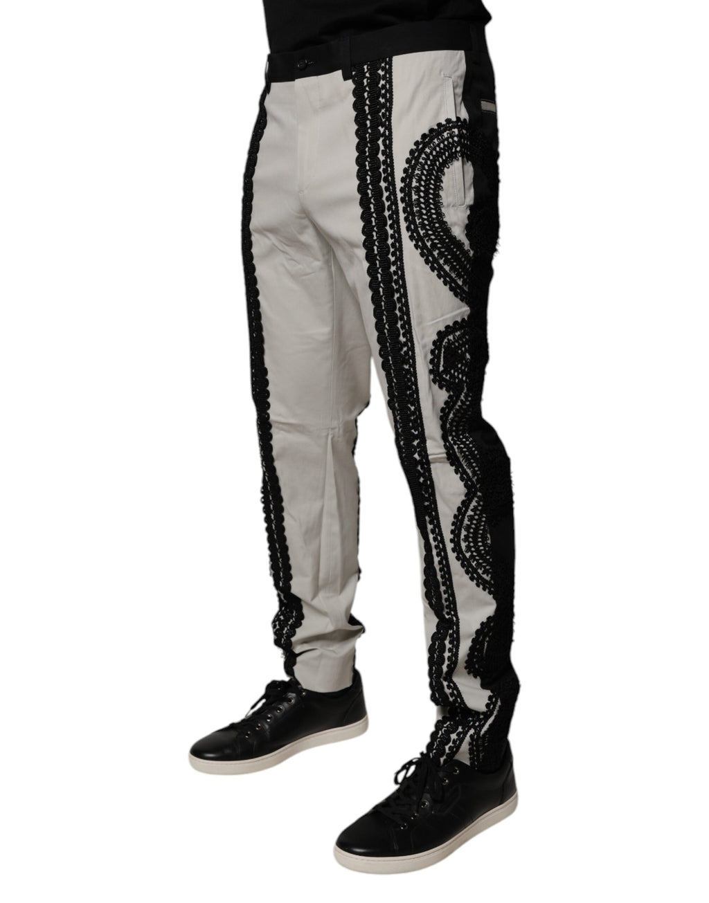 Pantalon formel blanc Dolce & Gabbana avec détails en dentelle, taille mi-haute et coupe élégante.