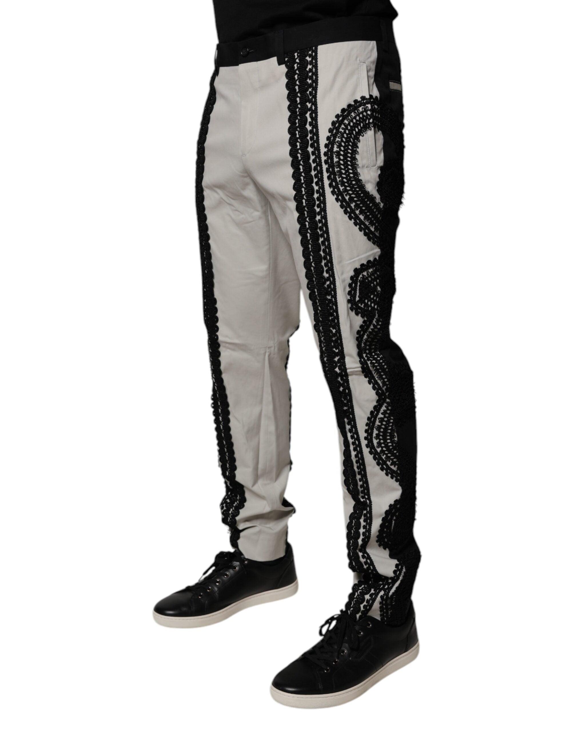 Pantalon formel blanc Dolce & Gabbana avec détails en dentelle, taille mi-haute et coupe élégante.
