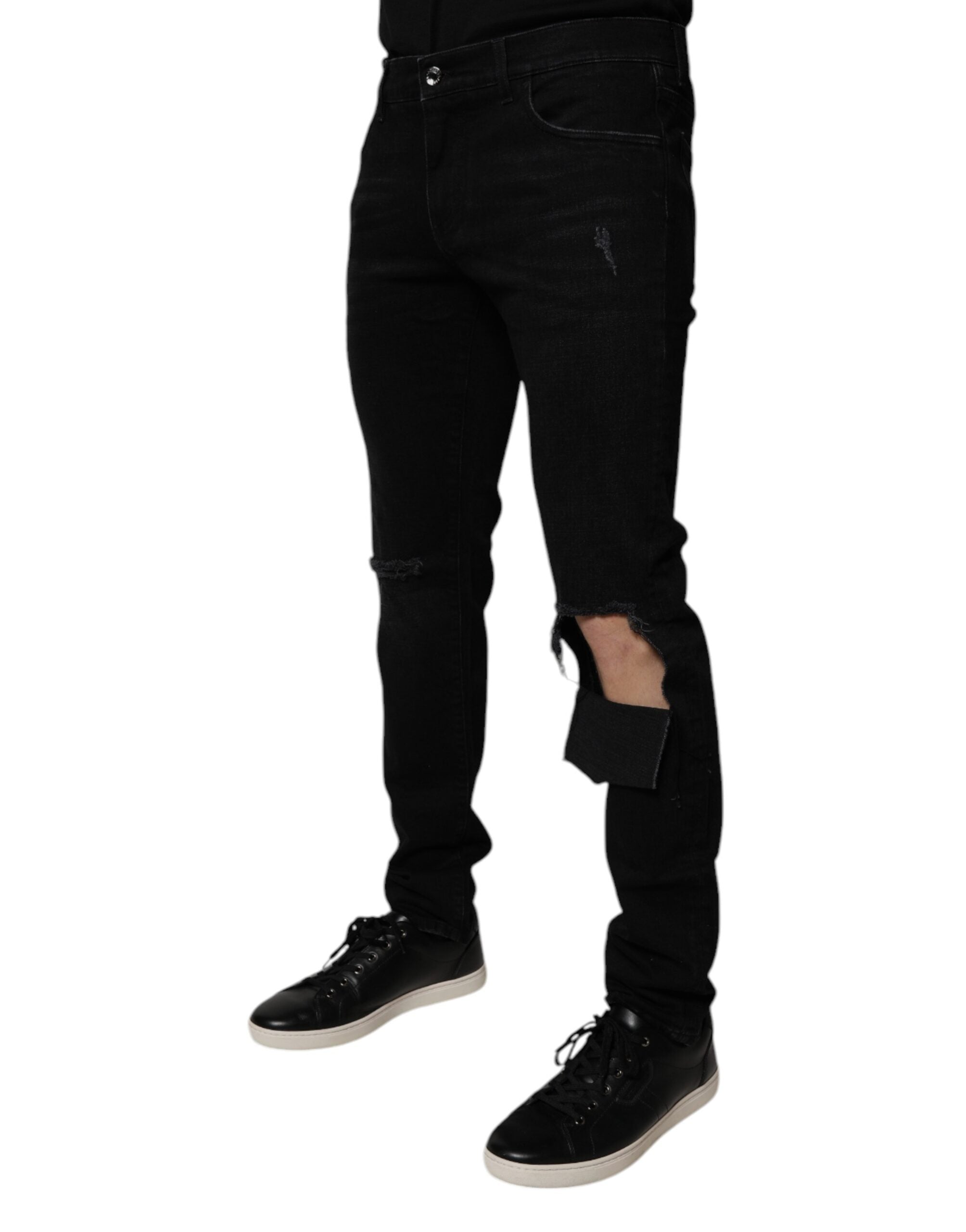 Jeans skinny noirs en coton déchiré de Dolce & Gabbana pour homme, denim ajusté avec détails usés.
