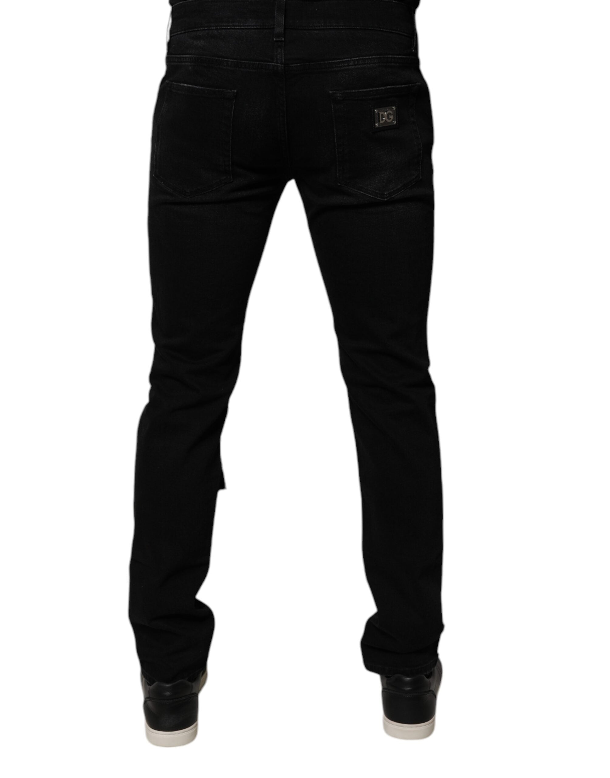 Jeans slim en denim noir déchiré pour homme de Dolce & Gabbana, coupe skinny avec détails usés.
