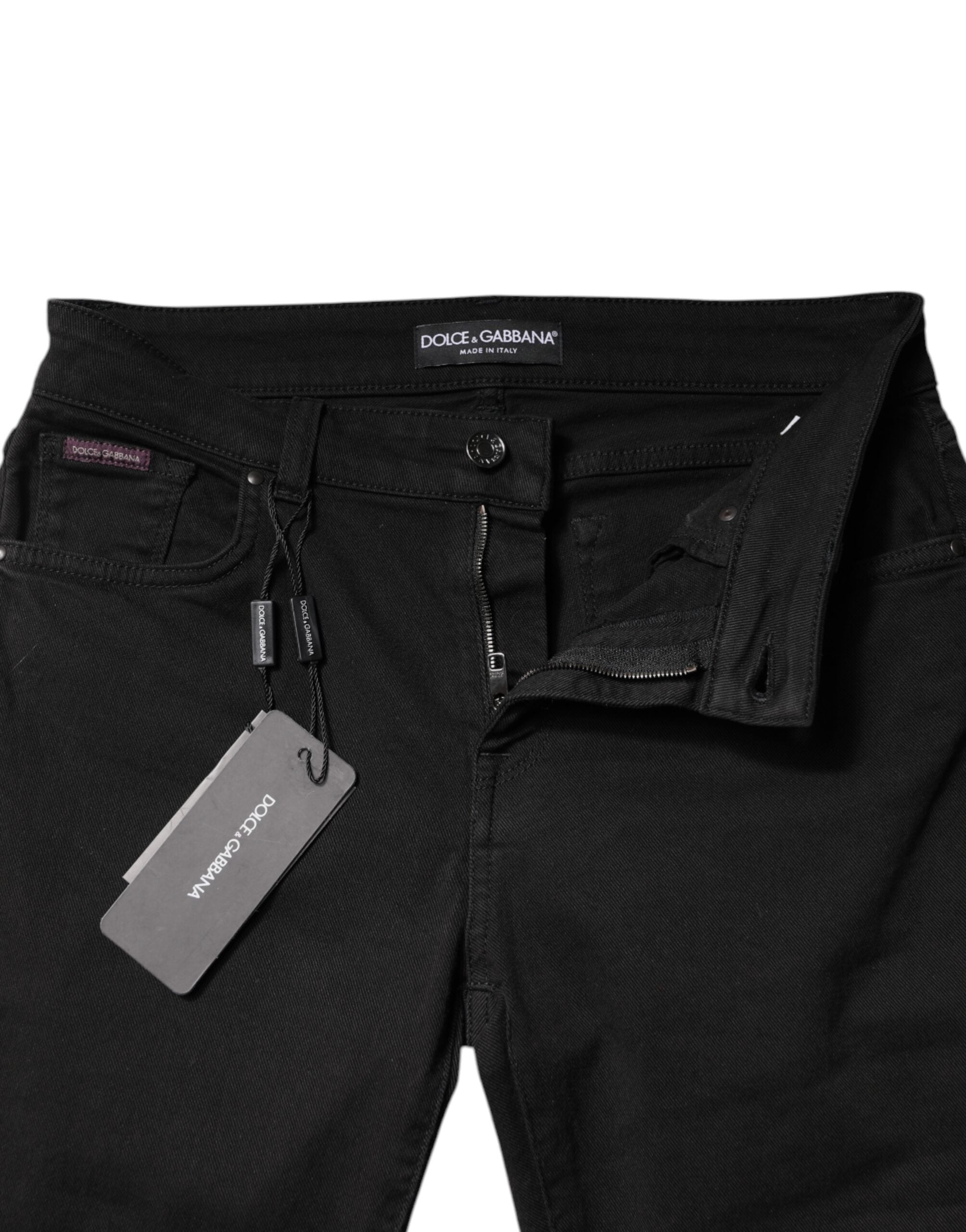 Jeans skinny en coton noir Dolce & Gabbana à taille moyenne, vue de face, détails de la coupe moulante et de la texture du denim.