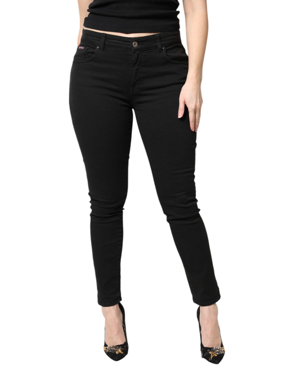 Jeans skinny en coton noir taille moyenne de Dolce & Gabbana, coupe ajustée et moderne, visibles sur le mannequin.