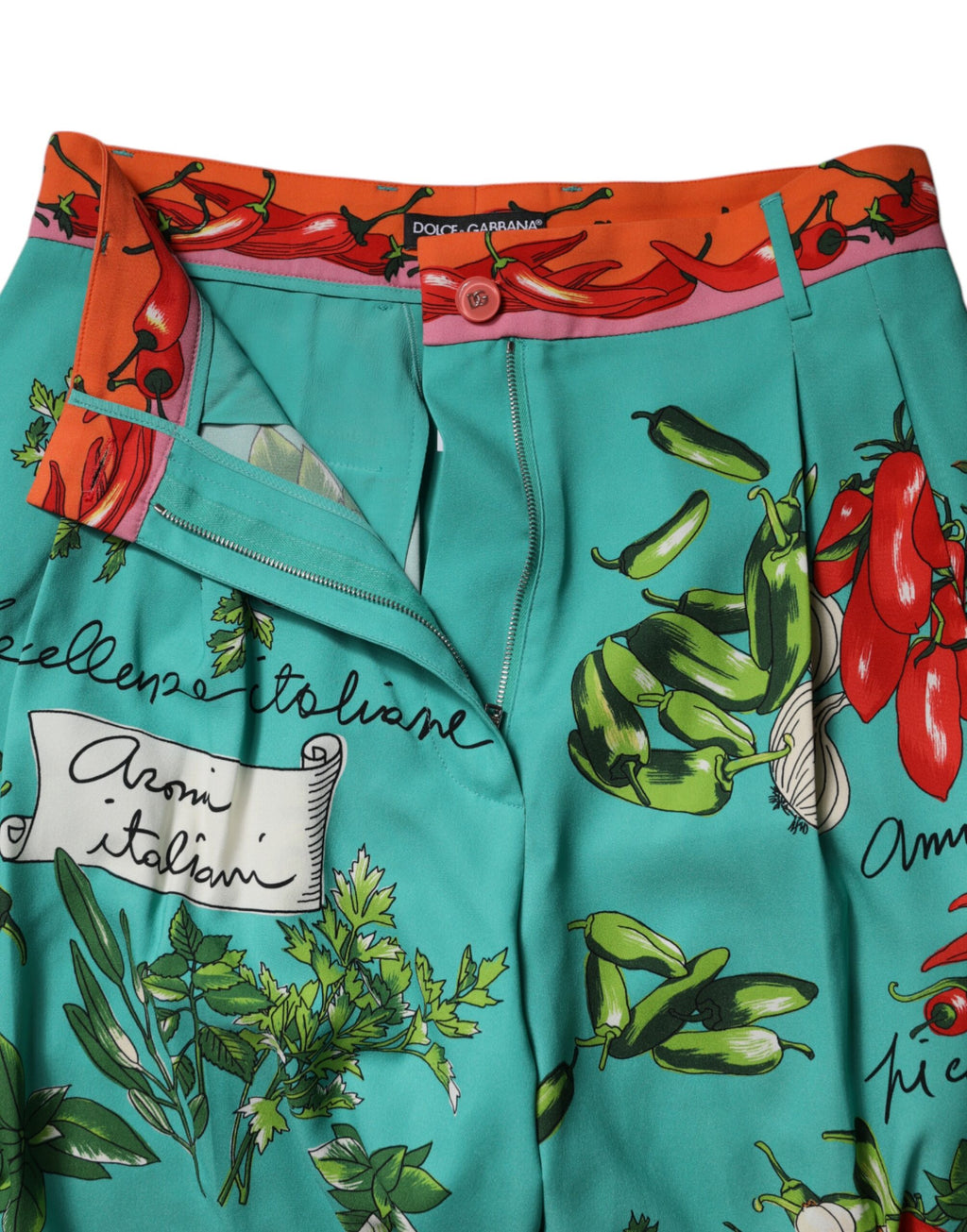 Pantalons droits en soie verte imprimée de Dolce & Gabbana, vue de face avec détails de motif élégant.