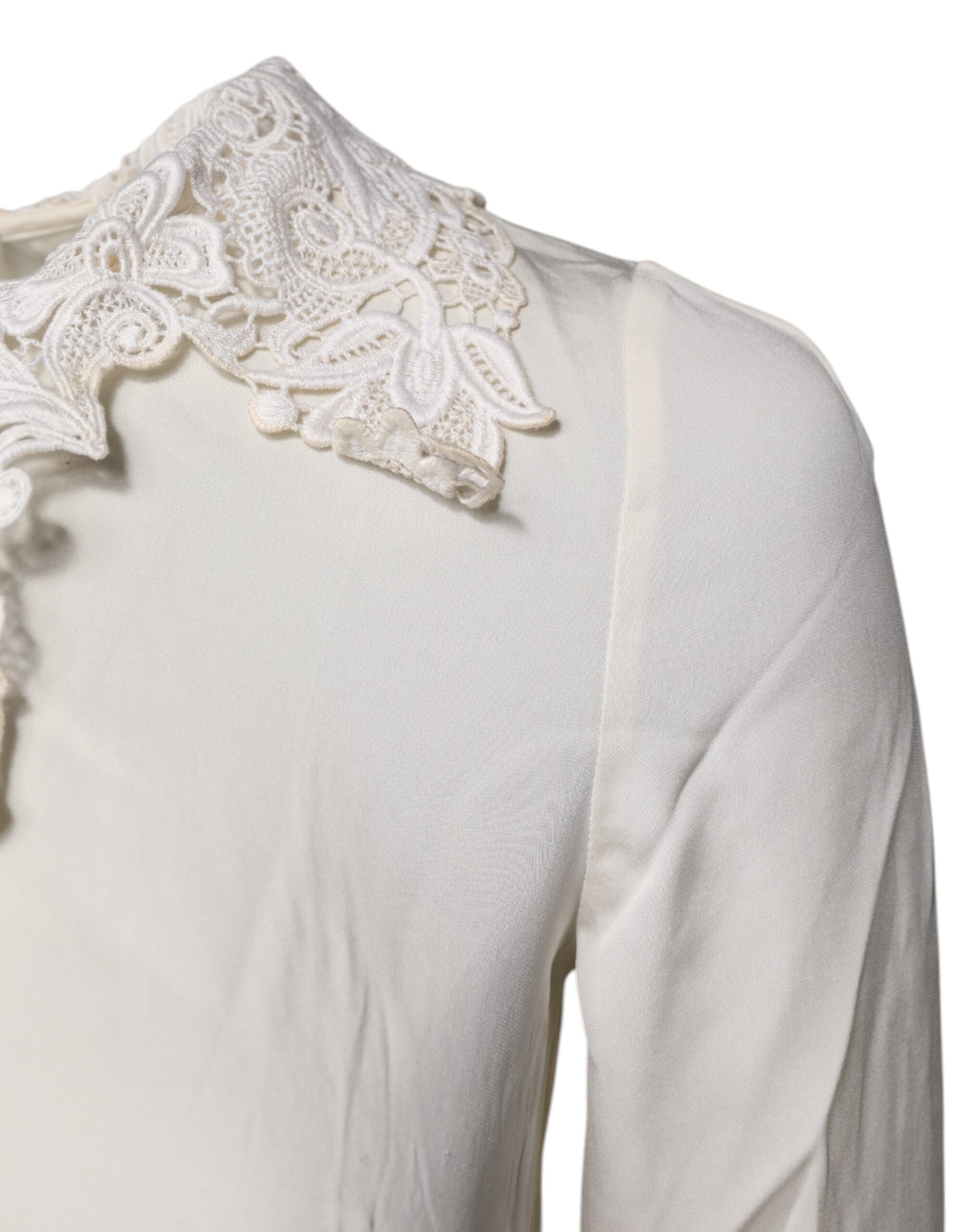 Blouse Dolce & Gabbana en dentelle florale crème à manches longues, élégante et raffinée, vue de face.