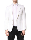 Manteau pour homme Dolce & Gabbana blanc à un bouton, veste blazer classique en tissu élégant, porté sur un fond neutre.