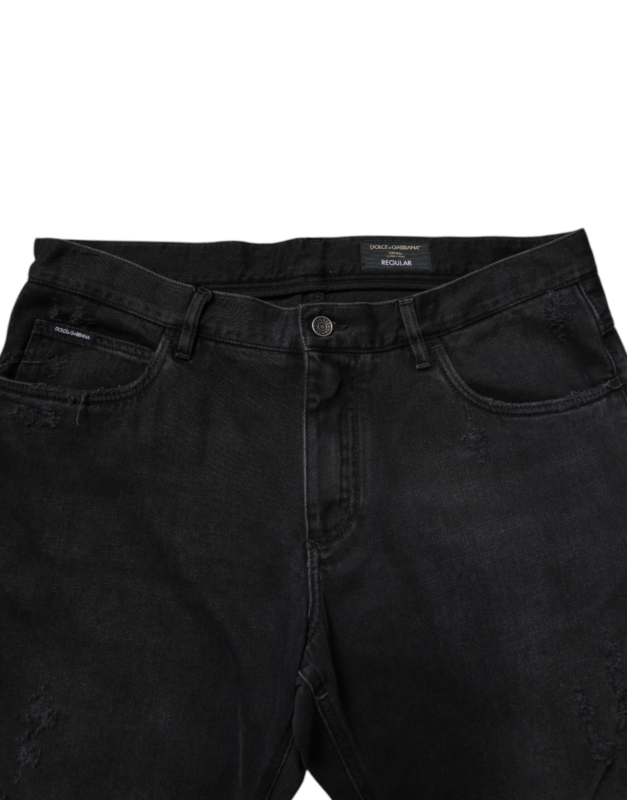 Jeans slim en coton noir Dolce & Gabbana pour homme, coupe ajustée et style élégant, visibles en gros plan.