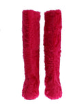 Bottes plates en cuir rose avec fourrure de mouton, marque Dolce & Gabbana, visibles avec détails de finition et semelle.