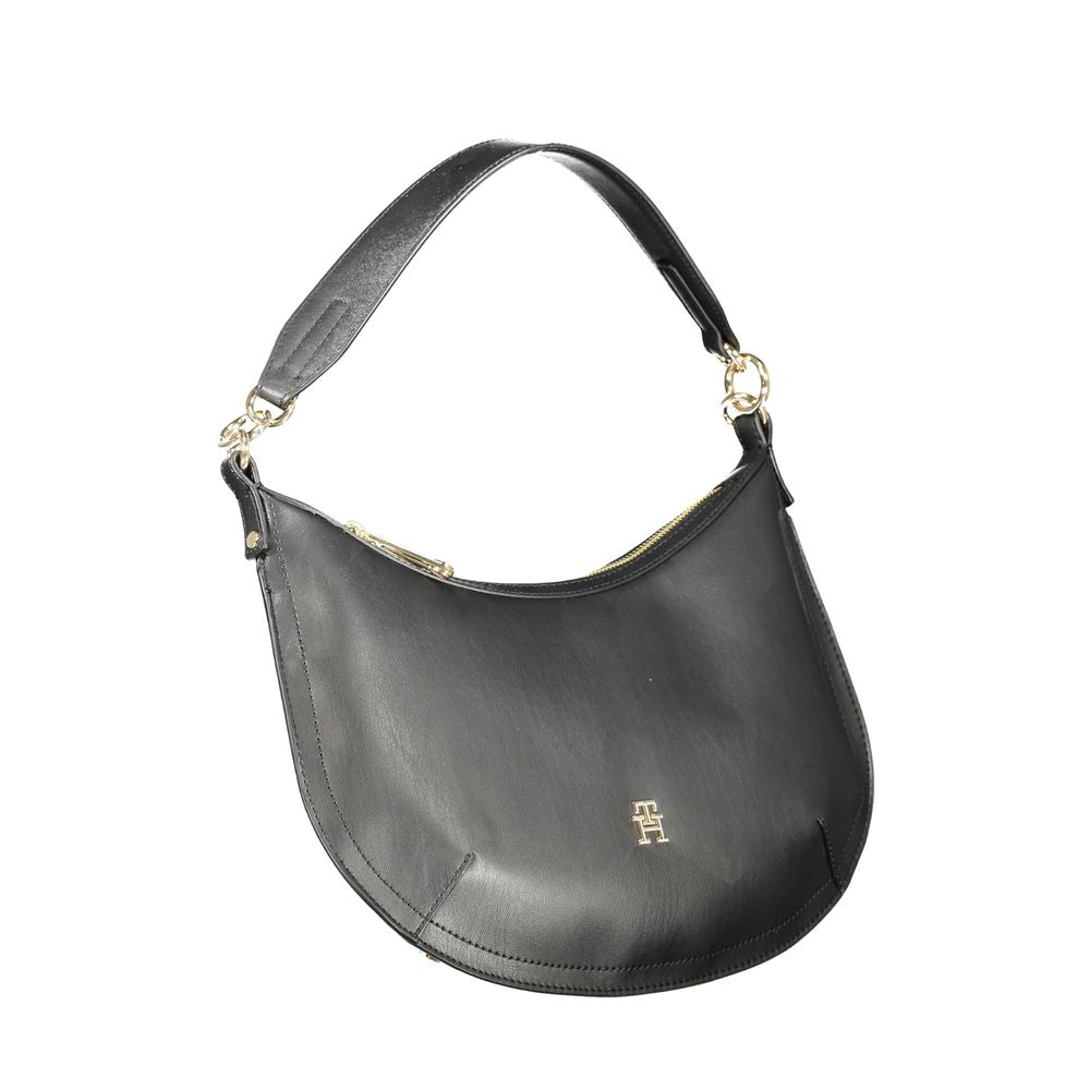 Sac à main noir en polyuréthane pour femmes de Tommy Hilfiger, avec bandoulière et détails élégants visible dans l'image.