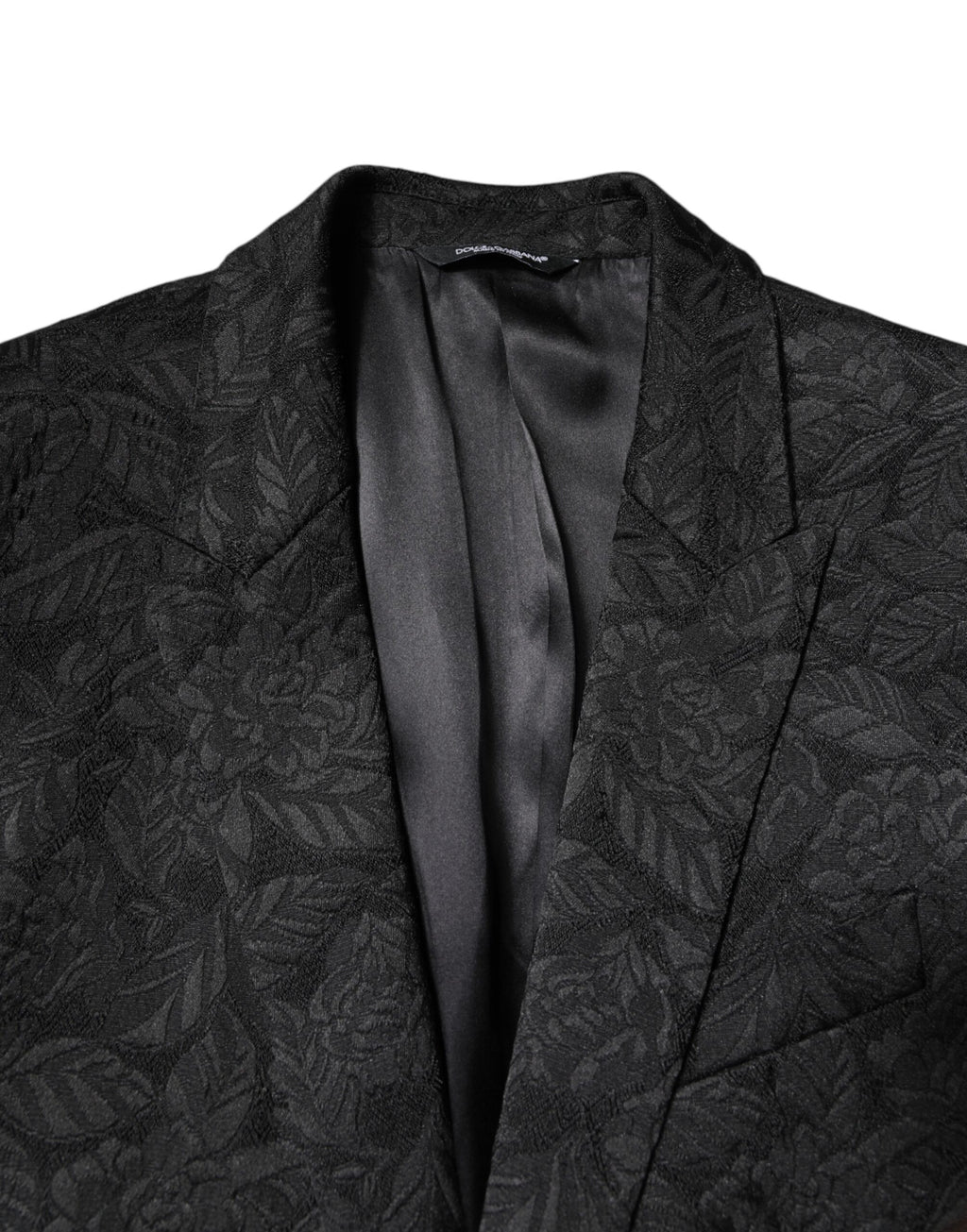 Blazer noir en brocart Dolce & Gabbana MARTINI à simple boutonnage, élégant et sophistiqué, visible en détail sur l’image.